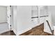 Upstairs hallway featuring hardwood floors, arched entryways, and white trim at 1231 Ellington Ct, Cumming, GA 30041