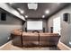 Home theater room with reclining leather seating, large screen, and integrated surround sound system at 1231 Ellington Ct, Cumming, GA 30041