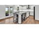 Bright kitchen featuring white cabinets, granite countertops, stainless steel appliances, and a large center island with seating at 1231 Ellington Ct, Cumming, GA 30041
