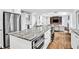 Spacious kitchen island with granite countertops, stainless appliances, and views of the home's living areas at 1231 Ellington Ct, Cumming, GA 30041