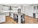 Spacious kitchen features white cabinets, stainless steel appliances, and a large island with granite countertops and seating at 1231 Ellington Ct, Cumming, GA 30041