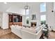 Open-concept living room featuring a fireplace, built-in shelving, and soaring windows at 1231 Ellington Ct, Cumming, GA 30041