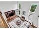 Aerial view of a living room with a fireplace, built-ins, and a soaring ceiling with chandelier at 1231 Ellington Ct, Cumming, GA 30041
