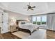 Bright main bedroom with a tray ceiling, hardwood floor, and large windows at 1231 Ellington Ct, Cumming, GA 30041