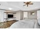 Large main bedroom with a tray ceiling, hardwood floors, and a large TV at 1231 Ellington Ct, Cumming, GA 30041