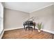 Room with hardwood floors, piano, and neutral-colored walls at 1231 Ellington Ct, Cumming, GA 30041