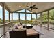 Relaxing screened-in porch with scenic views, comfortable seating, and ceiling fan for ultimate comfort at 1231 Ellington Ct, Cumming, GA 30041