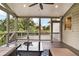 Screened porch with modern ceiling fan and back yard views at 1231 Ellington Ct, Cumming, GA 30041