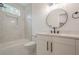 Charming bathroom with a tub, marble tile surround and modern vanity at 1273 Grayson Pkwy, Grayson, GA 30017