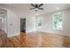 Bright bedroom featuring hardwood floors, windows, and fresh paint at 1273 Grayson Pkwy, Grayson, GA 30017