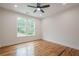 Bright bedroom with hardwood floors and a large window offering a backyard view at 1273 Grayson Pkwy, Grayson, GA 30017