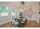 Dining room features modern lighting fixture, stylish wall art, and large windows at 1273 Grayson Pkwy, Grayson, GA 30017