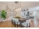 Dining area with modern light fixture, large table and chairs, and view to living room at 1273 Grayson Pkwy, Grayson, GA 30017