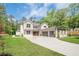 Gorgeous two-story home with modern design, a large driveway, and professionally landscaped yard at 1273 Grayson Pkwy, Grayson, GA 30017