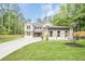 Charming two-story home featuring stone accents, three-car garage, and a well-manicured lawn at 1273 Grayson Pkwy, Grayson, GA 30017