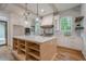 Bright kitchen with a large island, stainless steel appliances, and white cabinets with gold hardware at 1273 Grayson Pkwy, Grayson, GA 30017