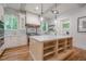 Bright kitchen with a large island, stainless steel appliances, and white cabinets with gold hardware at 1273 Grayson Pkwy, Grayson, GA 30017