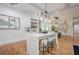 Modern kitchen with island seating, stone countertops, stainless appliances, and wood floors at 1273 Grayson Pkwy, Grayson, GA 30017
