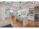 Beautiful white kitchen with a large island, modern lighting, and hardwood floors at 1273 Grayson Pkwy, Grayson, GA 30017
