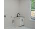 Laundry room featuring a sink, storage cabinets, and a window at 1273 Grayson Pkwy, Grayson, GA 30017