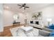 Open-concept living room with hardwood floors, stylish furnishings, and a modern white coffee table at 1273 Grayson Pkwy, Grayson, GA 30017
