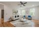 Bright living room with hardwood floors, ceiling fan, and lots of natural light from two windows at 1273 Grayson Pkwy, Grayson, GA 30017