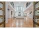 Open-concept living room with hardwood floors, a high ceiling, and a chandelier at 1273 Grayson Pkwy, Grayson, GA 30017