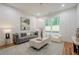 Living room featuring stylish decor, modern lighting, and a large window view at 1273 Grayson Pkwy, Grayson, GA 30017