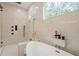 Elegant bathroom featuring large soaking tub, designer fixtures and tiling at 1273 Grayson Pkwy, Grayson, GA 30017