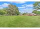 Spacious backyard featuring a large lawn, mature trees, and a wooden fence at 1419 Gates Mill Walk, Lawrenceville, GA 30045