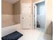 Bright bathroom featuring a soaking tub and tile flooring at 1419 Gates Mill Walk, Lawrenceville, GA 30045