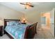 Bedroom with blue comforter, neutral carpet, and ceiling fan at 1419 Gates Mill Walk, Lawrenceville, GA 30045