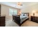 Bedroom with neutral carpet, ceiling fan, and coordinating furniture set at 1419 Gates Mill Walk, Lawrenceville, GA 30045