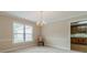 Bright dining room with a chandelier, large window, and neutral decor at 1419 Gates Mill Walk, Lawrenceville, GA 30045