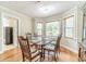 Charming dining room with wood floors, a bay window, and a glass table set for six at 1419 Gates Mill Walk, Lawrenceville, GA 30045