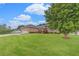 Manicured front lawn and mature landscaping add to the curb appeal of this charming brick home at 1419 Gates Mill Walk, Lawrenceville, GA 30045