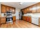Traditional kitchen with wood cabinets, stainless steel appliances, and hardwood floors at 1419 Gates Mill Walk, Lawrenceville, GA 30045