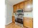 Modern stainless steel appliances and wooden cabinets create a functional and stylish kitchen space at 1419 Gates Mill Walk, Lawrenceville, GA 30045