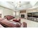 Spacious living room featuring a fireplace, large TV, and comfortable leather furniture at 1419 Gates Mill Walk, Lawrenceville, GA 30045
