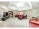 Spacious living room with a trey ceiling, plush carpet, and a built-in bookshelf at 1419 Gates Mill Walk, Lawrenceville, GA 30045