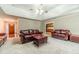 Cozy living room with plush carpeting and comfortable leather seating for relaxing and entertaining at 1419 Gates Mill Walk, Lawrenceville, GA 30045