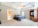 Main bedroom featuring a trey ceiling, carpet floors, and an en-suite bathroom at 1419 Gates Mill Walk, Lawrenceville, GA 30045