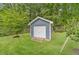 View of a detached, single-car garage in a residential backyard at 1419 Gates Mill Walk, Lawrenceville, GA 30045