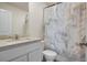Elegant bathroom features a marble-patterned shower curtain, a vanity, and modern fixtures at 217 Limestone Cir, Conyers, GA 30013