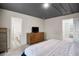 Cozy bedroom includes a dresser with a television and an ensuite bathroom at 217 Limestone Cir, Conyers, GA 30013