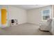 Spacious room with neutral paint, carpet, and a chair at 217 Limestone Cir, Conyers, GA 30013