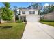 Charming two-story home with a well-manicured lawn and a concrete driveway leading to an attached two-car garage at 217 Limestone Cir, Conyers, GA 30013