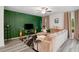 Cozy living room with a decorative green accent wall, plush seating, and stylish decor, creating a comfortable gathering space at 217 Limestone Cir, Conyers, GA 30013