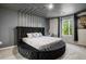 Stylish main bedroom features a unique tray ceiling, a round bed, and neutral decor at 217 Limestone Cir, Conyers, GA 30013