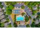 Aerial view of community pool, parking, playground and basketball court surrounded by lush green trees at 2275 Black Pebble Cir, Buford, GA 30519